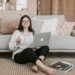 cheerful woman using laptop at home